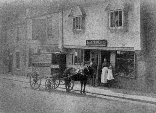Frederick Thompson Cross with wife Elizabeth, and daughter Daisy, outside their shop at Forehill, Ely, in 1892